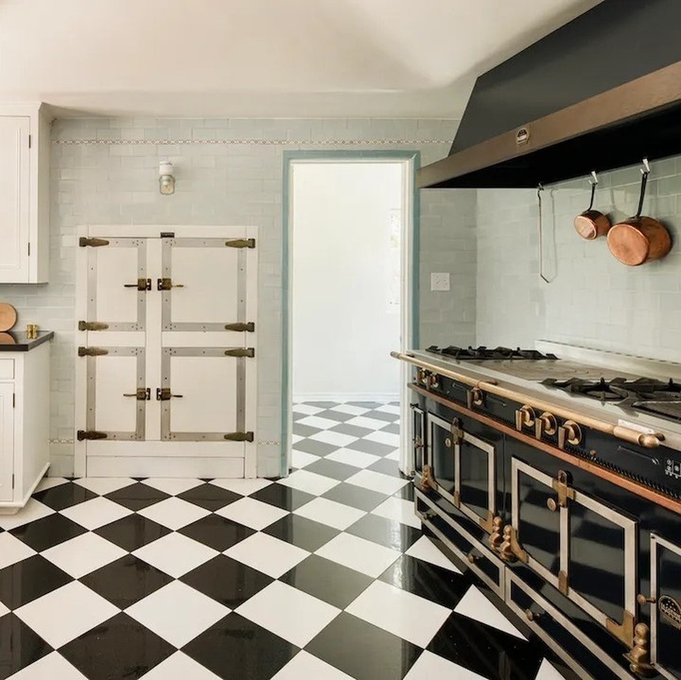 A cozinha tem o chão quadriculado e eletrodomésticos modernos — Foto: Robb Report / Instagram / Reprodução