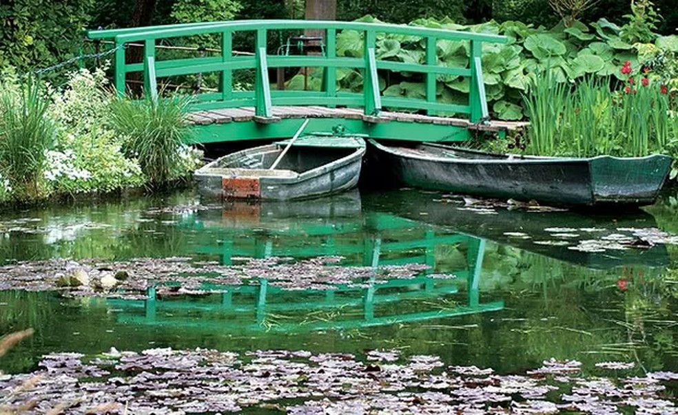 Esta é a famosa ponte japonesa, retratada por Monet em 45 obras. Os barcos eram utilizados como apoio na manutenção e limpeza das águas. O artista sempre utilizou o lago como espelho e jogo de reflexões em suas criações e representações de cores, luzes e sombras (Foto: Fernando Grilli) — Foto: Esta é a famosa ponte japonesa, retratada por Monet em 45 obras. Os barcos eram utilizados como apoio na manutenção e limpeza das águas. O artista sempre utilizou o lago como espelho e jogo de reflexões em suas criações e representações de cores, luzes e  (Foto: Fernando Grilli)