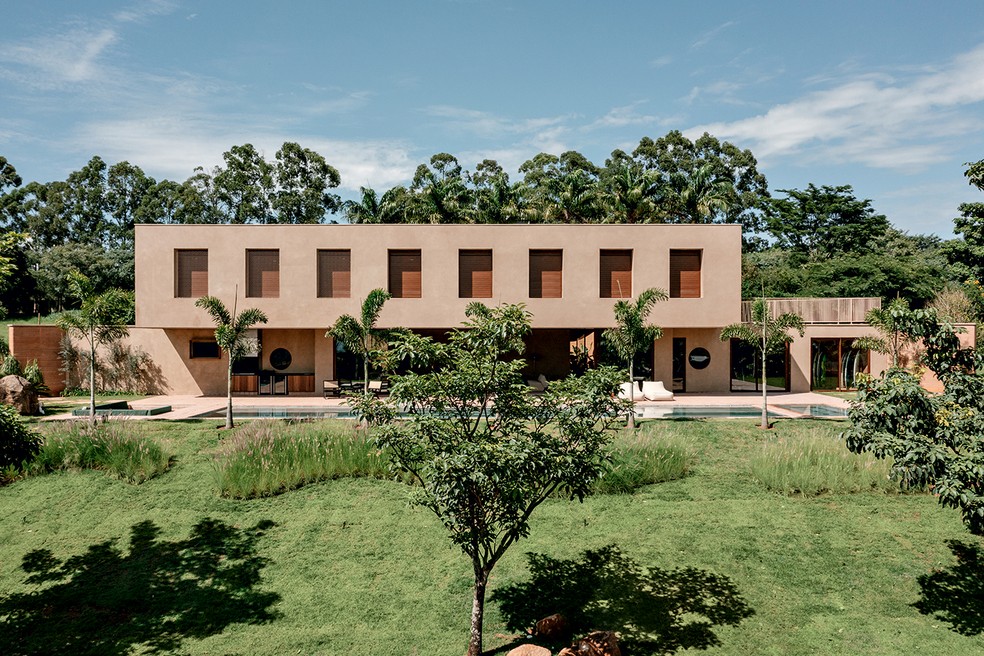 FACHADA | A fachada frontal da casa envolvida por jardim projetado pela Alalou Paisagismo — Foto: Fran Parente / Divulgação